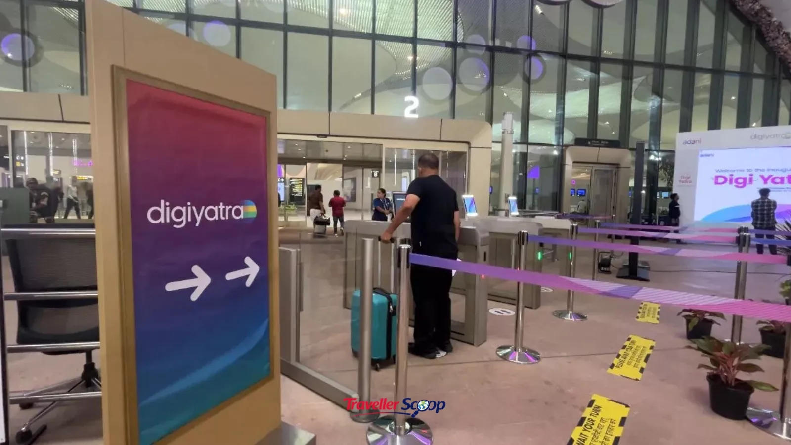 A passenger walking through a Digi Yatra e-gate at an airport terminal A passenger walking through a Digi Yatra e-gate at an airport terminal