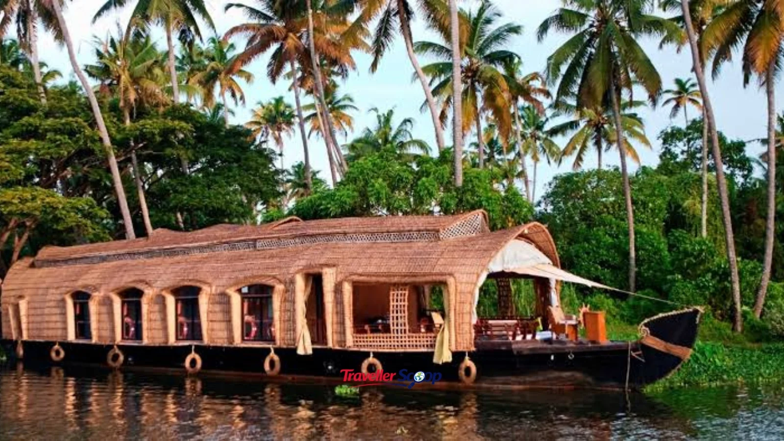 Traditional houseboat cruising calm backwaters in Alleppey, Kerala